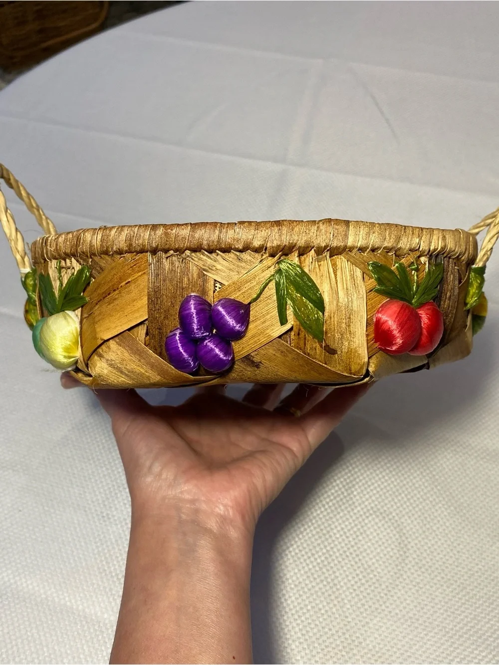 Hand Crafted woven accent basket with red, purple, yellow fruit trim